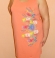 3-0495 Papaijas krāsas kleita ar ziedu zīmējumu